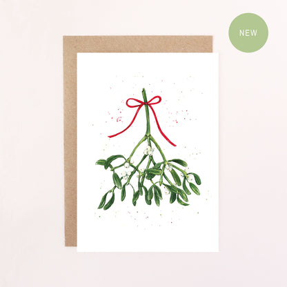 A greeting card illustration featuring a sprig of mistletoe tied with a red bow with a white background.